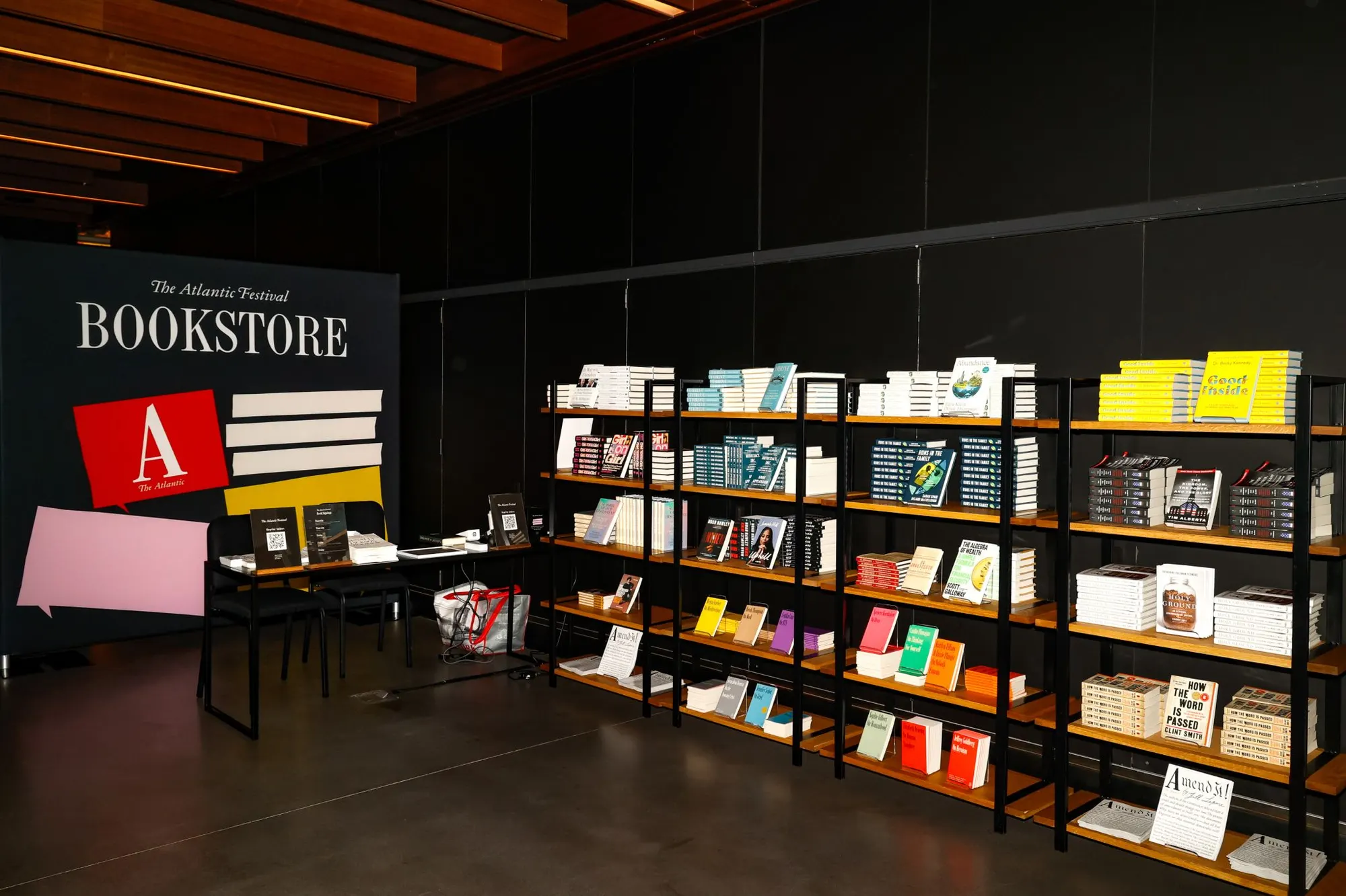 The festival bookstore, shelves of titles ranged under the store sign.