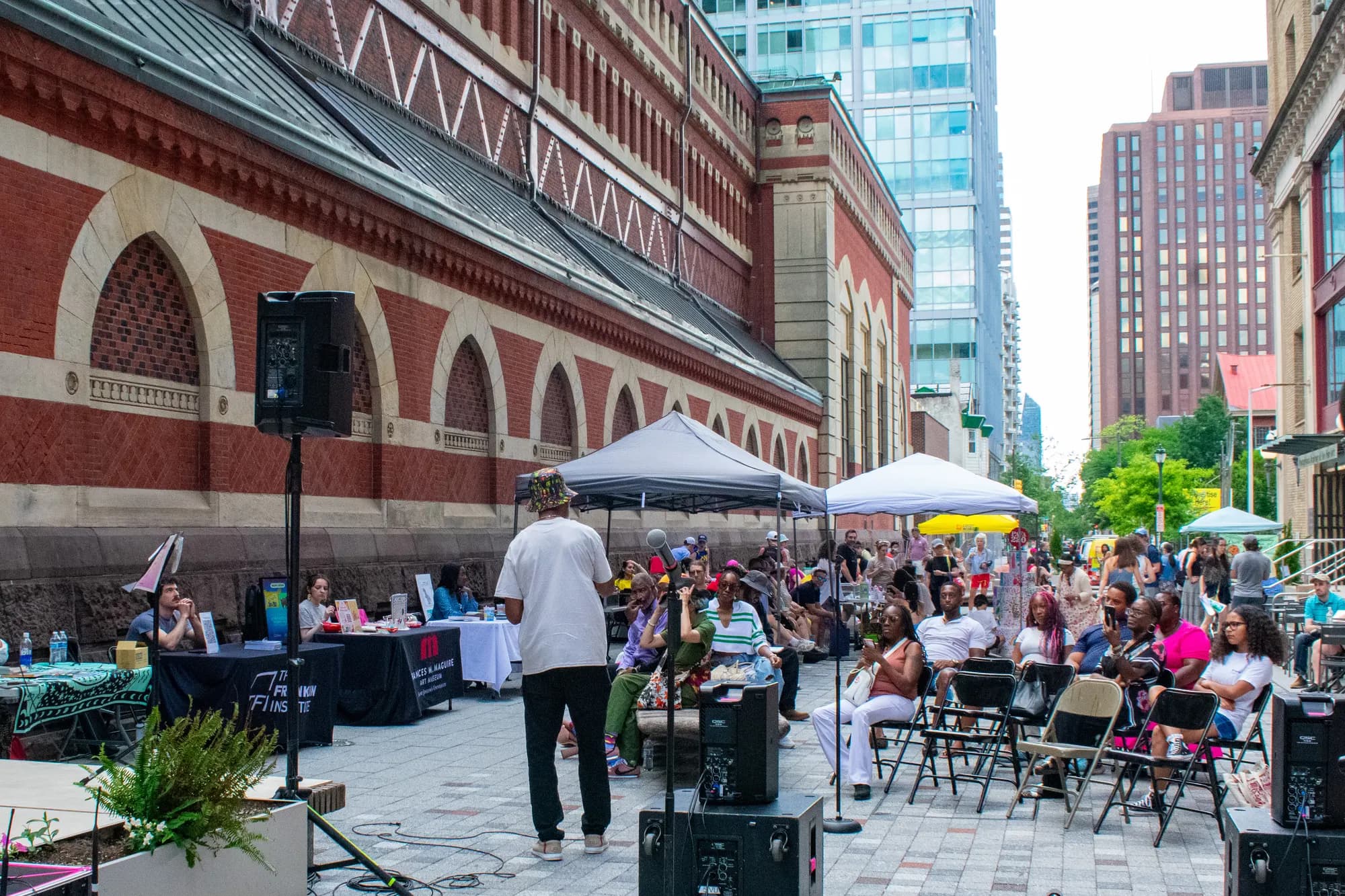 The street festival in full swing, tents and a stage set up beside the academy building.