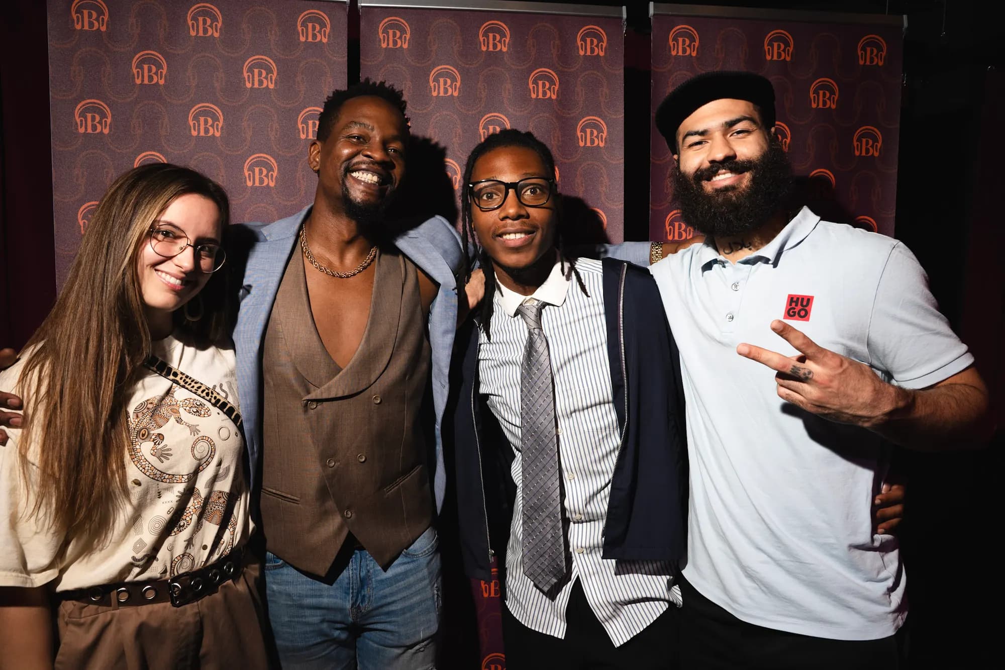 Three guests posed together at the red step-and-repeat.