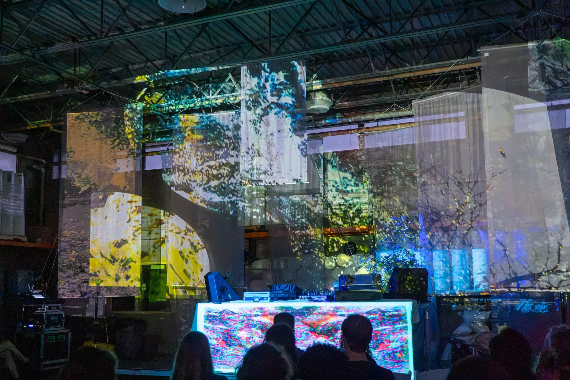 The audience watching a final projection sequence break into white and gold.